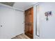 Bright entryway with a wood door, white sliding closet, and a key rack near the window at 9275 E Mission Ln # 206, Scottsdale, AZ 85258