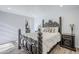 Bedroom features a decorative wooden bed frame, neutral walls, and laminate flooring at 9275 E Mission Ln # 206, Scottsdale, AZ 85258