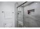 Modern shower with gray tile, built in storage niche, a glass door and updated fixtures at 9275 E Mission Ln # 206, Scottsdale, AZ 85258