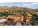 Stunning aerial view of a home with a terracotta tile roof, surrounded by golf course and mountain views at 9280 E Thompson Peak Pkwy # 25, Scottsdale, AZ 85255