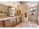 Spacious bathroom with double vanity, tile floor, and decorative accents at 9280 E Thompson Peak Pkwy # 25, Scottsdale, AZ 85255