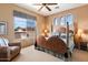 Relaxing bedroom with large windows, a ceiling fan, and southwestern decor at 9280 E Thompson Peak Pkwy # 25, Scottsdale, AZ 85255