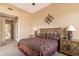 Comfortable bedroom with a decorative ship's wheel and matching nightstands at 9280 E Thompson Peak Pkwy # 25, Scottsdale, AZ 85255