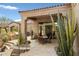 Spacious covered patio featuring a dining area and grill, with views of the serene desert landscape at 9280 E Thompson Peak Pkwy # 25, Scottsdale, AZ 85255