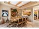 Rustic dining room with wooden beams, southwest decor, tile floor, and seating for six at 9280 E Thompson Peak Pkwy # 25, Scottsdale, AZ 85255