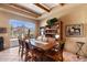 A dining room with a large window showcasing scenic views and exposed beam ceilings at 9280 E Thompson Peak Pkwy # 25, Scottsdale, AZ 85255