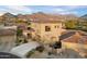 Beautiful home with a terracotta roof, complemented by desert landscaping and a view of the majestic mountains at 9280 E Thompson Peak Pkwy # 25, Scottsdale, AZ 85255