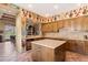 Bright kitchen features southwest-inspired decor, tile floors, an island, and wooden cabinets at 9280 E Thompson Peak Pkwy # 25, Scottsdale, AZ 85255