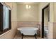 Relax in this clawfoot tub with a garden view from the nearby window at 9331 E La Posada Ct, Scottsdale, AZ 85255