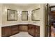 Vanity area showcases wood cabinetry, bright lighting, and a marble-topped countertop at 9331 E La Posada Ct, Scottsdale, AZ 85255