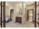 Traditional bathroom featuring dual entry, a vanity, and a classic clawfoot tub for luxurious soaking at 9331 E La Posada Ct, Scottsdale, AZ 85255