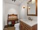 Powder room with an antique vanity, pendant lights, and a decorative framed mirror at 9331 E La Posada Ct, Scottsdale, AZ 85255