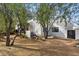 Landscaped yard with a white stucco home and black trim at 9331 E La Posada Ct, Scottsdale, AZ 85255