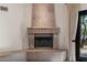 Elegant fireplace with detailed stonework and hearth, adjacent to a large window at 9331 E La Posada Ct, Scottsdale, AZ 85255