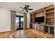 Bright living room boasting custom built-ins, tile floors, and natural light at 9331 E La Posada Ct, Scottsdale, AZ 85255