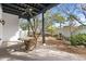 Covered outdoor patio featuring an outdoor dining space and manicured landscaping at 9331 E La Posada Ct, Scottsdale, AZ 85255