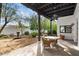 Covered outdoor patio featuring an outdoor dining space and manicured landscaping at 9331 E La Posada Ct, Scottsdale, AZ 85255