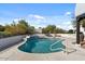 Sparkling pool surrounded by lush landscaping and clear blue skies, ideal for outdoor enjoyment at 9331 E La Posada Ct, Scottsdale, AZ 85255