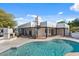 Backyard pool area featuring a spiral staircase, outdoor fireplace, and lush landscaping at 9331 E La Posada Ct, Scottsdale, AZ 85255