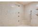 Luxurious shower with multiple shower heads, tile surround, and a built-in seat at 9331 E La Posada Ct, Scottsdale, AZ 85255