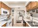 Charming kitchen featuring a white microwave, oven, light countertops, and wood cabinetry at 9345 N 92Nd St # 201, Scottsdale, AZ 85258