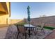 Patio features table, chairs, artificial grass and privacy wall, for outdoor enjoyment at 9539 W Agora Ln, Tolleson, AZ 85353