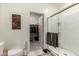 Clean bathroom featuring a glass-enclosed shower and a view into the walk-in closet at 9539 W Agora Ln, Tolleson, AZ 85353