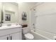 Well-lit bathroom with white cabinets, a tub and shower combination, and modern fixtures at 9539 W Agora Ln, Tolleson, AZ 85353