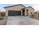 Inviting home featuring a two-car garage, desert landscaping, and a welcoming entryway at 9539 W Agora Ln, Tolleson, AZ 85353