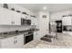 Contemporary kitchen with granite countertops, stainless steel appliances, and sleek white cabinetry at 9539 W Agora Ln, Tolleson, AZ 85353