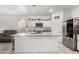 Modern kitchen featuring granite countertops, stainless steel appliances, and ample cabinet space at 9539 W Agora Ln, Tolleson, AZ 85353