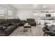 Spacious living room features wood floors, bright white walls, and stylish furniture at 9539 W Agora Ln, Tolleson, AZ 85353