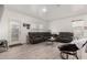 Spacious living room with a large sectional sofa, a modern rug, and bright natural light at 9539 W Agora Ln, Tolleson, AZ 85353