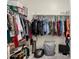 Well-organized walk-in closet with ample storage and a patterned laundry basket at 9539 W Agora Ln, Tolleson, AZ 85353