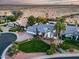 Stunning aerial view of a home with a circular driveway, manicured lawn, desert landscaping, and nearby desert landscape at 9921 E Doubletree Ranch Rd, Scottsdale, AZ 85258