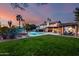 Expansive backyard featuring a large pool, lush green grass, and a beautiful home at 9921 E Doubletree Ranch Rd, Scottsdale, AZ 85258