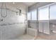 Modern bathroom with a glass-enclosed shower, a built-in bench, a decorative tile accent, and a window at 9921 E Doubletree Ranch Rd, Scottsdale, AZ 85258