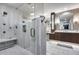 This primary bath includes a seamless glass shower and white tiled flooring at 9921 E Doubletree Ranch Rd, Scottsdale, AZ 85258