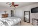 Comfortable bedroom with neutral carpet, ceiling fan, and a full-length mirror, offering a serene retreat at 9921 E Doubletree Ranch Rd, Scottsdale, AZ 85258