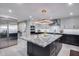 Bright kitchen featuring a large island with granite countertop and stainless steel refrigerator at 9921 E Doubletree Ranch Rd, Scottsdale, AZ 85258