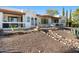 Inviting back patio with a covered seating area and a landscaped backyard at 100 N Lazy Fox Rd # 3, Wickenburg, AZ 85390