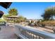 Desert backyard featuring a tiled patio with shade umbrella and desert landscaping with mountain views at 100 N Lazy Fox Rd # 3, Wickenburg, AZ 85390