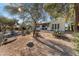 Desert-style backyard featuring native plants, gravel, and the rear of a charming home with arched windows at 100 N Lazy Fox Rd # 3, Wickenburg, AZ 85390