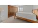 Bedroom featuring wood framed bed, plush mattress, dark wood closet, and a bright window at 100 N Lazy Fox Rd # 3, Wickenburg, AZ 85390