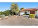 Inviting home exterior with desert landscaping, featuring agave plants and native vegetation at 100 N Lazy Fox Rd # 3, Wickenburg, AZ 85390