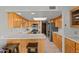 Well-lit kitchen featuring tile floors, wooden cabinets, and ample counter space at 100 N Lazy Fox Rd # 3, Wickenburg, AZ 85390