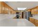 Spacious kitchen featuring light wood cabinetry, white countertops, and modern appliances at 100 N Lazy Fox Rd # 3, Wickenburg, AZ 85390