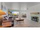 Bright living room features tile flooring, a cozy fireplace, and large windows with beautiful views at 100 N Lazy Fox Rd # 3, Wickenburg, AZ 85390