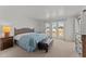 Bright primary bedroom with arched windows and wood furniture at 100 N Lazy Fox Rd # 3, Wickenburg, AZ 85390