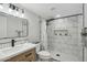 Modern bathroom featuring marble tile, glass shower, updated vanity and hexagon tile accents at 10252 N 46Th Dr, Glendale, AZ 85302